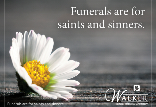 A white daisy on a dark wood surface with the text: 